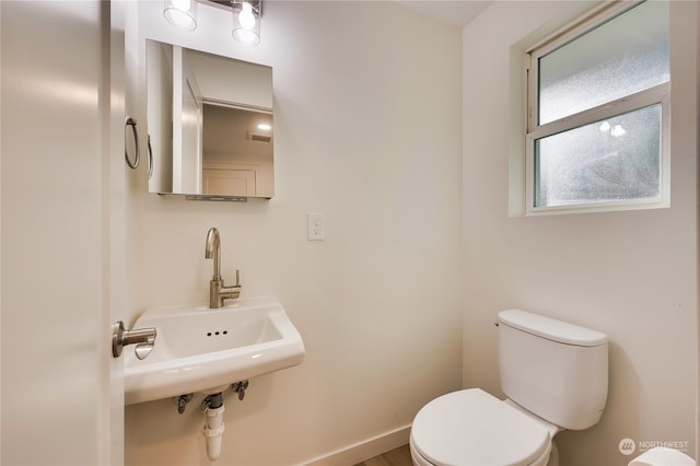 bathroom featuring toilet and sink