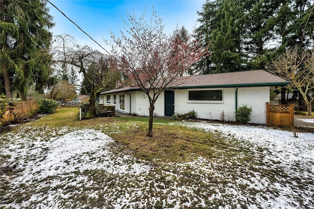 view of snow covered exterior featuring a lawn