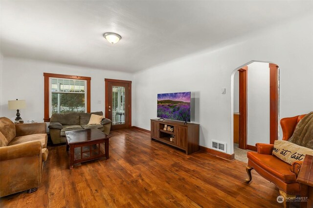 living room featuring dark wood-type flooring