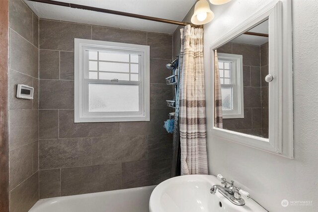 bathroom featuring shower / tub combo and sink