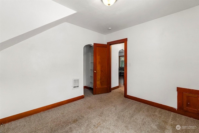 spare room featuring light colored carpet