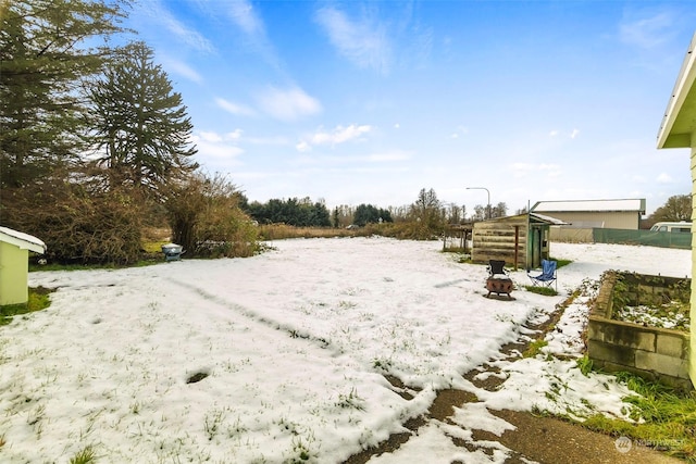 view of yard layered in snow