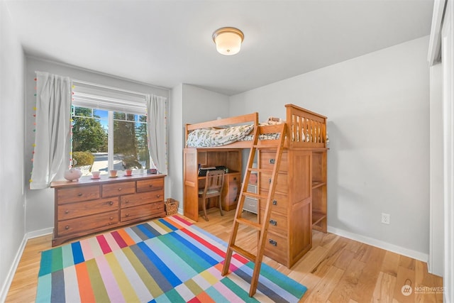 bedroom with hardwood / wood-style flooring