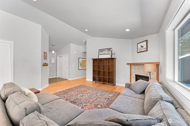 living room with vaulted ceiling and light hardwood / wood-style floors