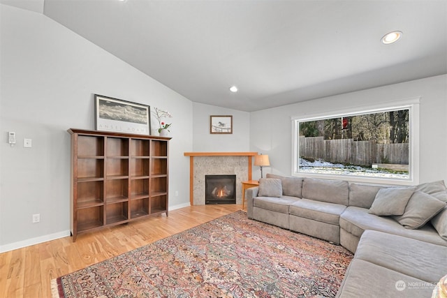 living room featuring lofted ceiling and hardwood / wood-style floors