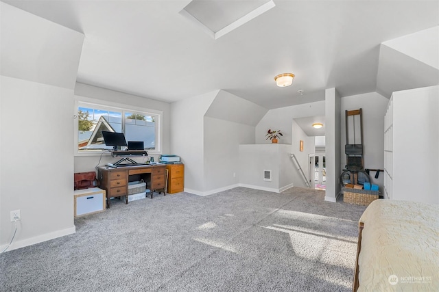 carpeted home office featuring vaulted ceiling