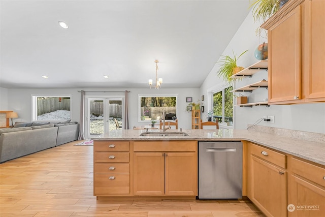 kitchen with sink, light hardwood / wood-style floors, light brown cabinetry, stainless steel dishwasher, and kitchen peninsula