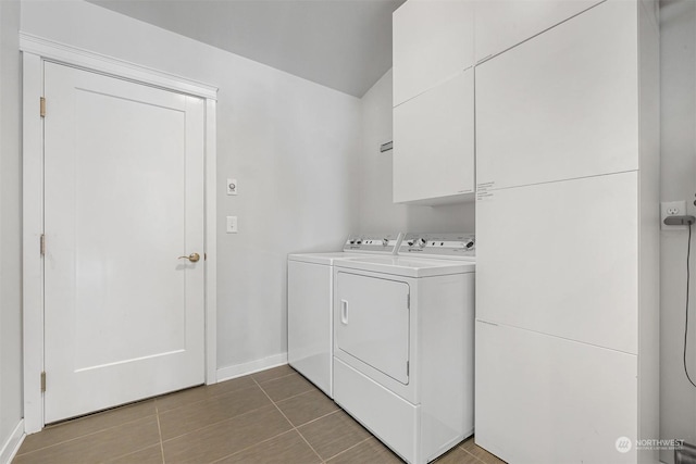 washroom featuring cabinets, tile patterned floors, and washer and clothes dryer