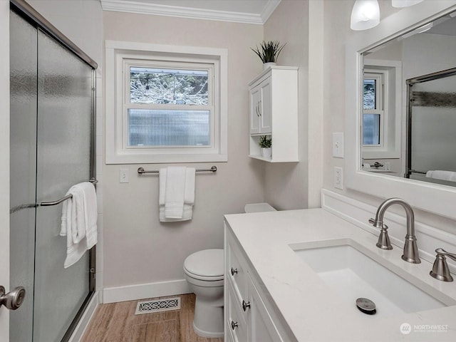 bathroom featuring hardwood / wood-style floors, a shower with shower door, and ornamental molding