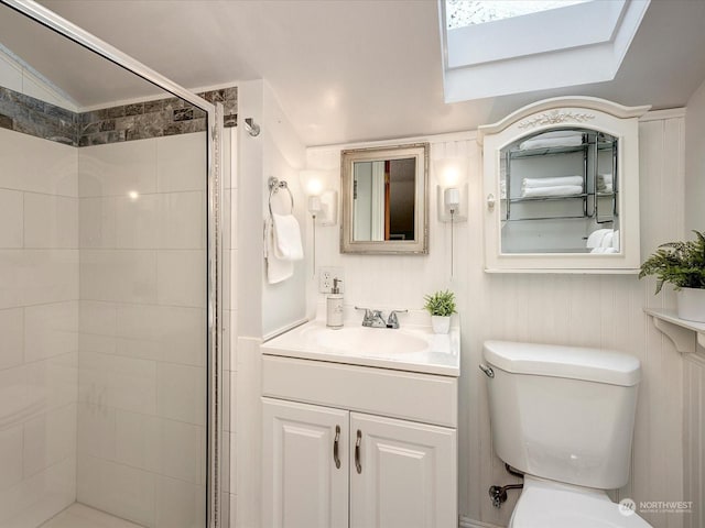 bathroom featuring vaulted ceiling, vanity, toilet, and a shower with door