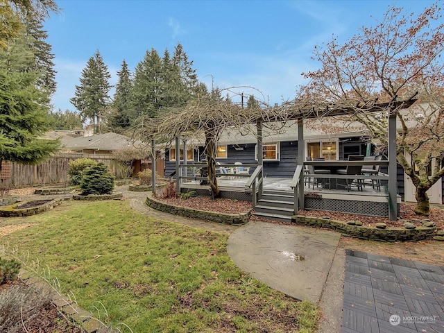 rear view of house with a yard and a deck