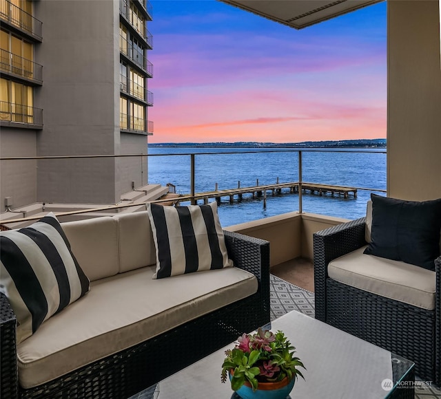 1600 43rd Ave E Unit 204, Seattle, WA 98112 - balcony at dusk featuring an outdoor living space and a water view