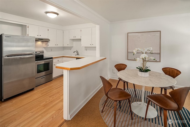 1600 43rd Ave E Unit 204, Seattle, WA 98112 - kitchen featuring white cabinetry, sink, kitchen peninsula, stainless steel appliances, and crown molding