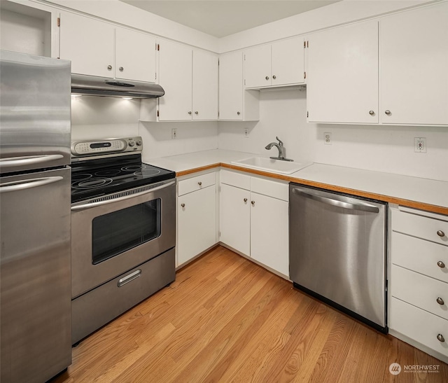 1600 43rd Ave E Unit 204, Seattle, WA 98112 - kitchen featuring sink, light hardwood / wood-style flooring, stainless steel appliances, and white cabinets