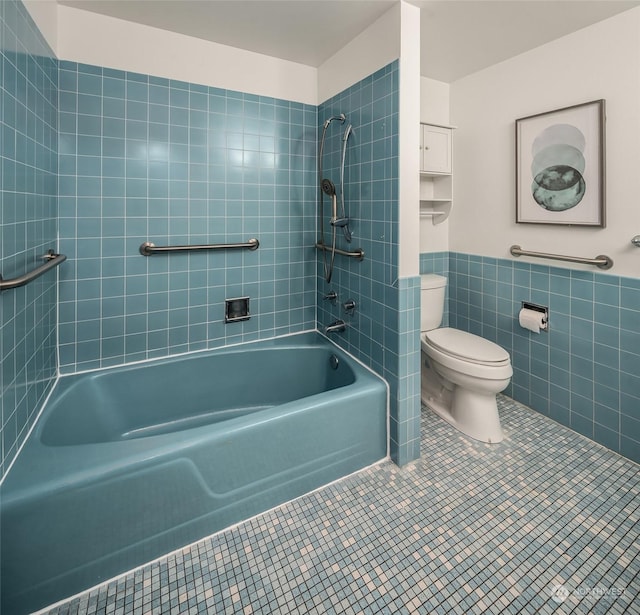 1600 43rd Ave E Unit 204, Seattle, WA 98112 - bathroom with tile walls, tile patterned floors, toilet, and tiled shower / bath