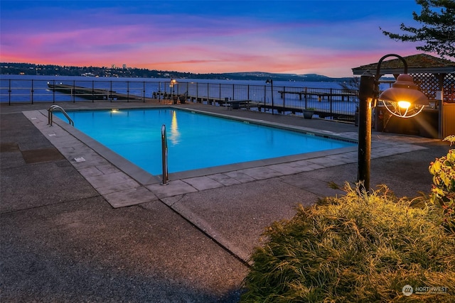 1600 43rd Ave E Unit 204, Seattle, WA 98112 - pool at dusk featuring a water view and a patio area
