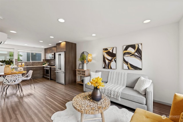 living room featuring hardwood / wood-style flooring and sink