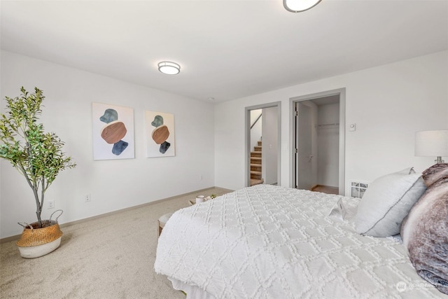 bedroom featuring carpet flooring and a spacious closet