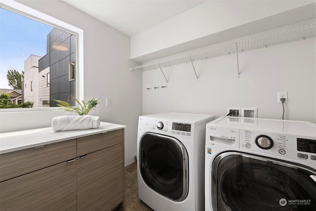 clothes washing area with washing machine and dryer