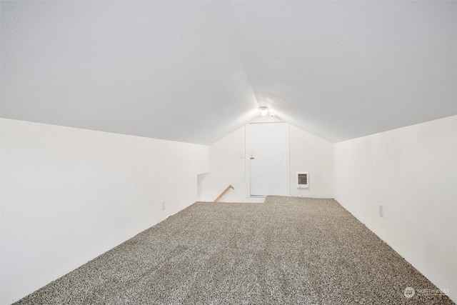 bonus room featuring lofted ceiling and carpet flooring