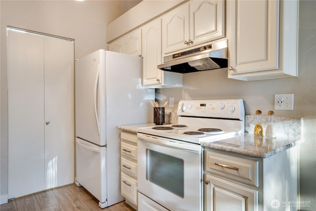 kitchen featuring light stone counters, white appliances, and light hardwood / wood-style flooring