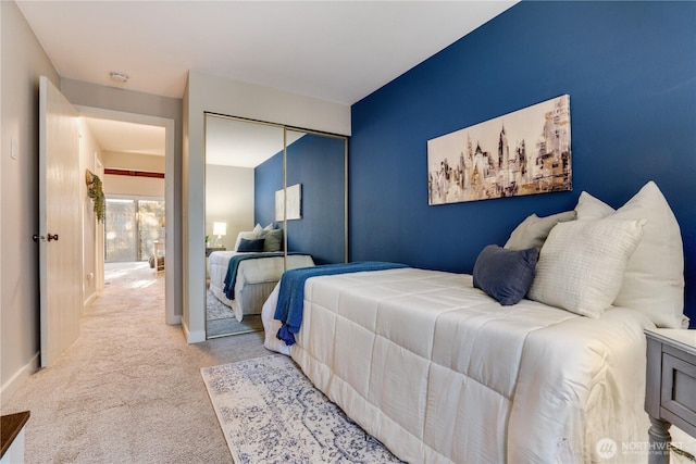 bedroom with light carpet and a closet