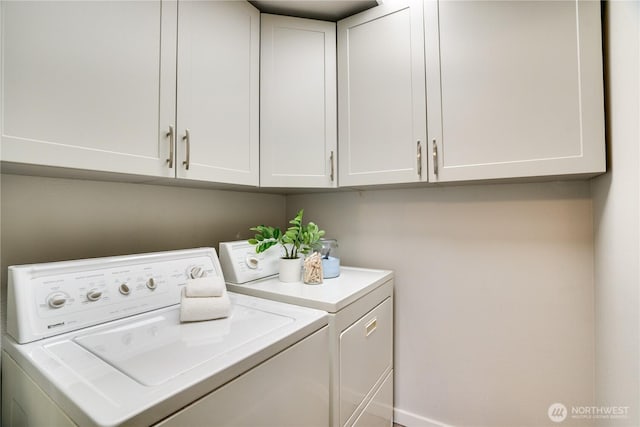 washroom featuring cabinets and independent washer and dryer