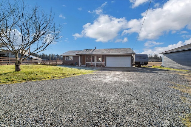 view of front of property featuring driveway, an attached garage, covered porch, fence, and a front lawn