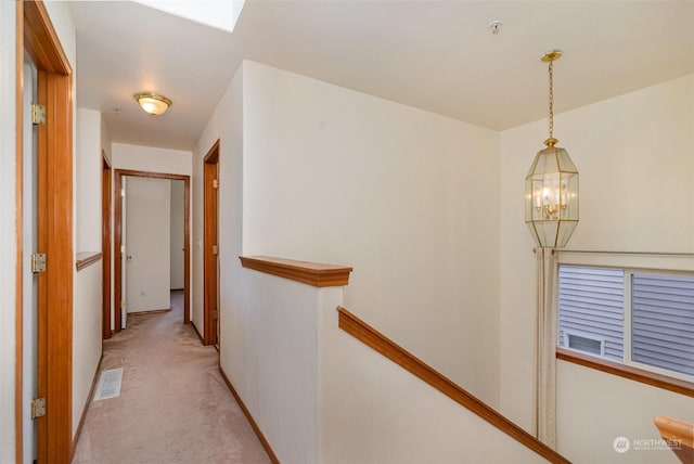 hallway featuring light carpet