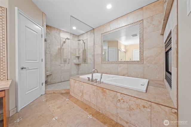 bathroom with tile walls, recessed lighting, a stall shower, vanity, and a bath