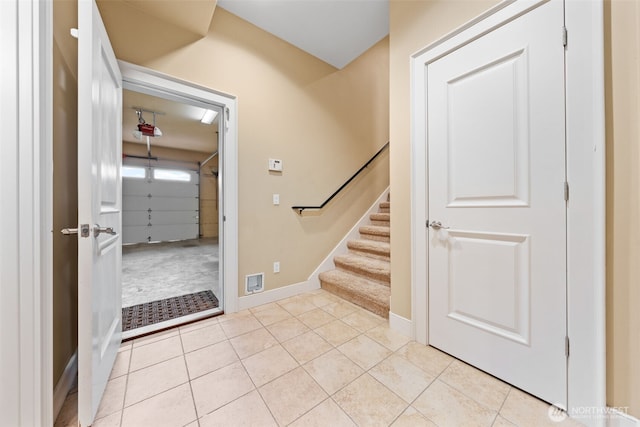 entrance foyer featuring light tile patterned flooring, visible vents, and baseboards