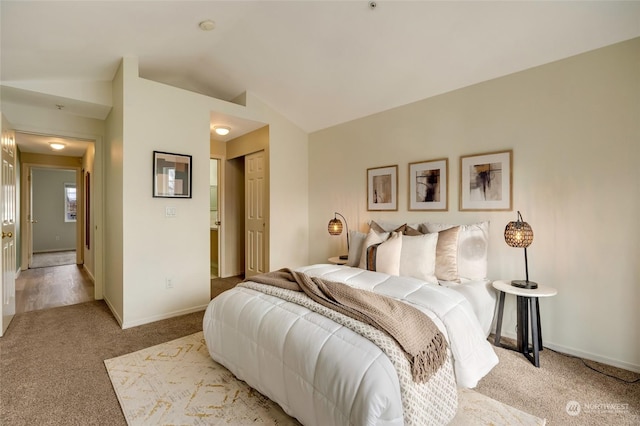 bedroom with lofted ceiling and carpet floors