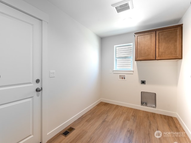 laundry area featuring hookup for a washing machine, electric dryer hookup, cabinets, and light hardwood / wood-style flooring