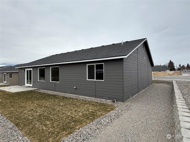 view of home's exterior featuring a patio area and a lawn