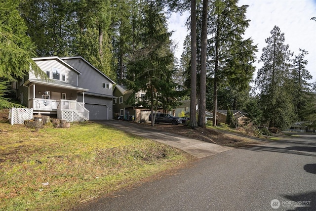 view of front facade with a porch, concrete driveway, and a garage