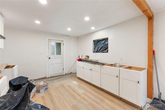 interior space with white cabinetry and light wood-type flooring