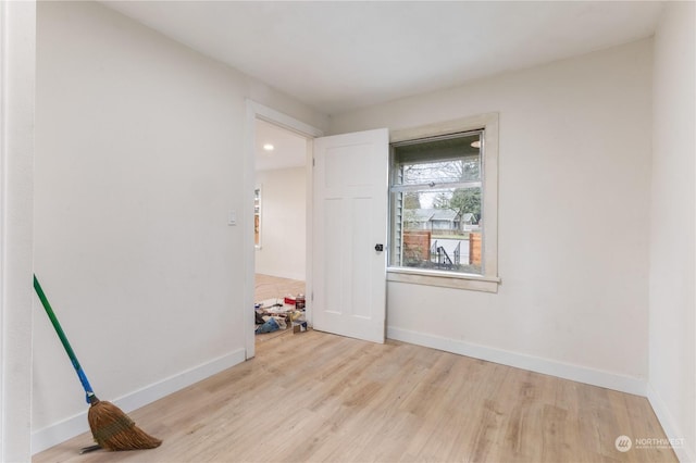 empty room with light hardwood / wood-style flooring