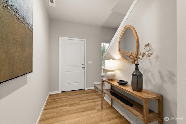 hallway with light hardwood / wood-style flooring