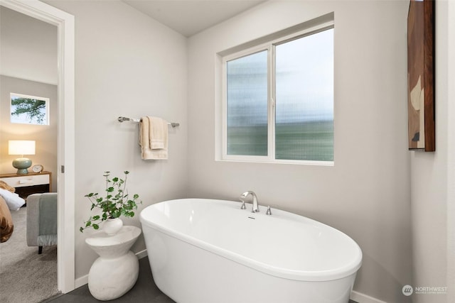 bathroom with a tub to relax in