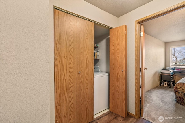 laundry room with washer / dryer and a textured ceiling