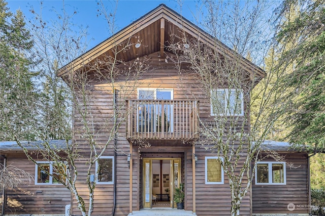 back of house featuring a balcony