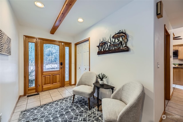 tiled foyer entrance with beam ceiling