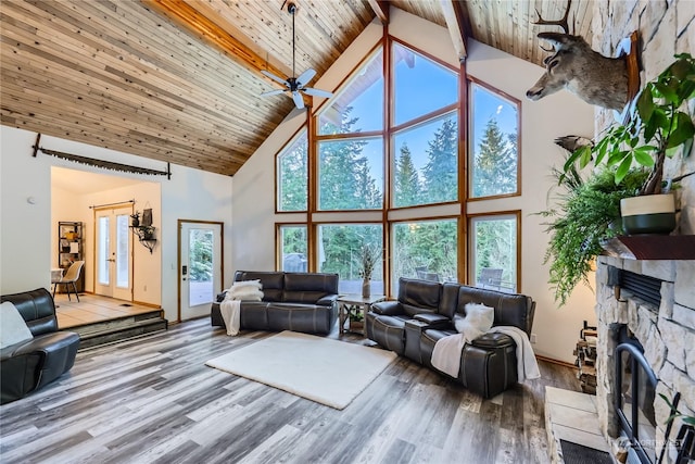 living room with high vaulted ceiling, hardwood / wood-style floors, a fireplace, and wood ceiling