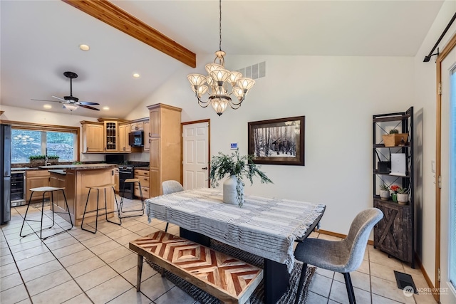 dining space featuring light tile patterned flooring, ceiling fan with notable chandelier, wine cooler, and vaulted ceiling with beams