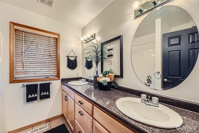 bathroom with tile patterned floors and vanity