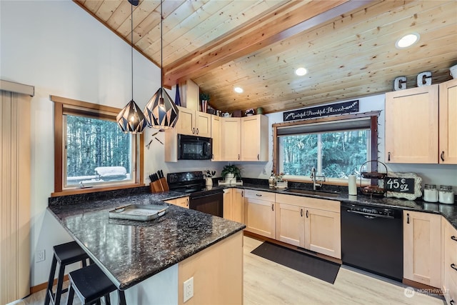 kitchen with pendant lighting, black appliances, sink, dark stone counters, and kitchen peninsula