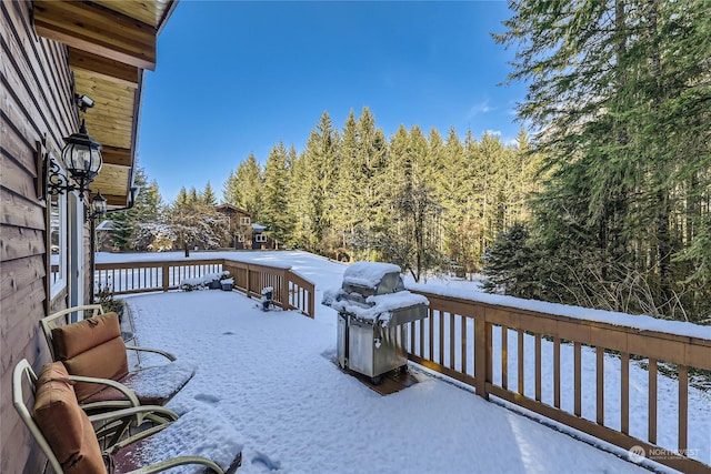 snow covered deck featuring area for grilling