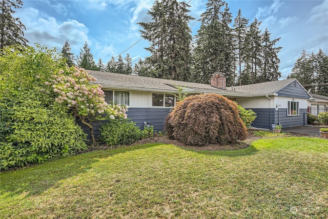 view of side of home with a yard