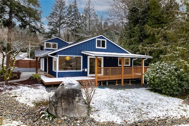 snow covered property with a wooden deck