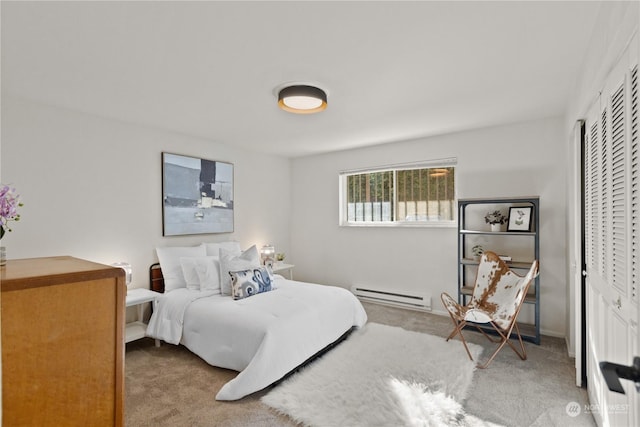 bedroom with a baseboard radiator and carpet